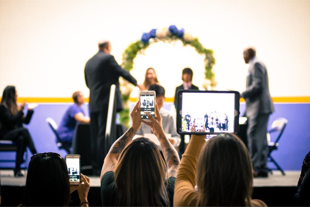 parents with mobile devices at graduation 2023 11 27 05 19 01 utc