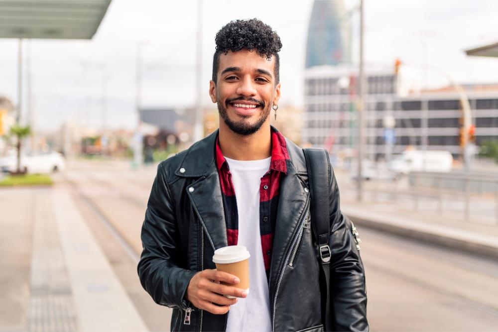 young latin guy smiles with a coffee on his hand 2023 11 27 04 54 56 utc